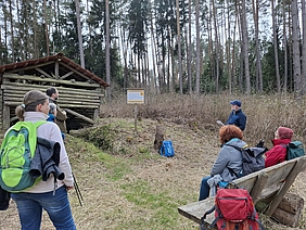 Pilger, die im Wald Pause auf Holzbank machen