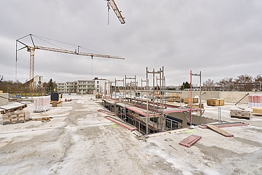 	Blick auf das Dach mit Baugerüst und Kran im Hintergrund